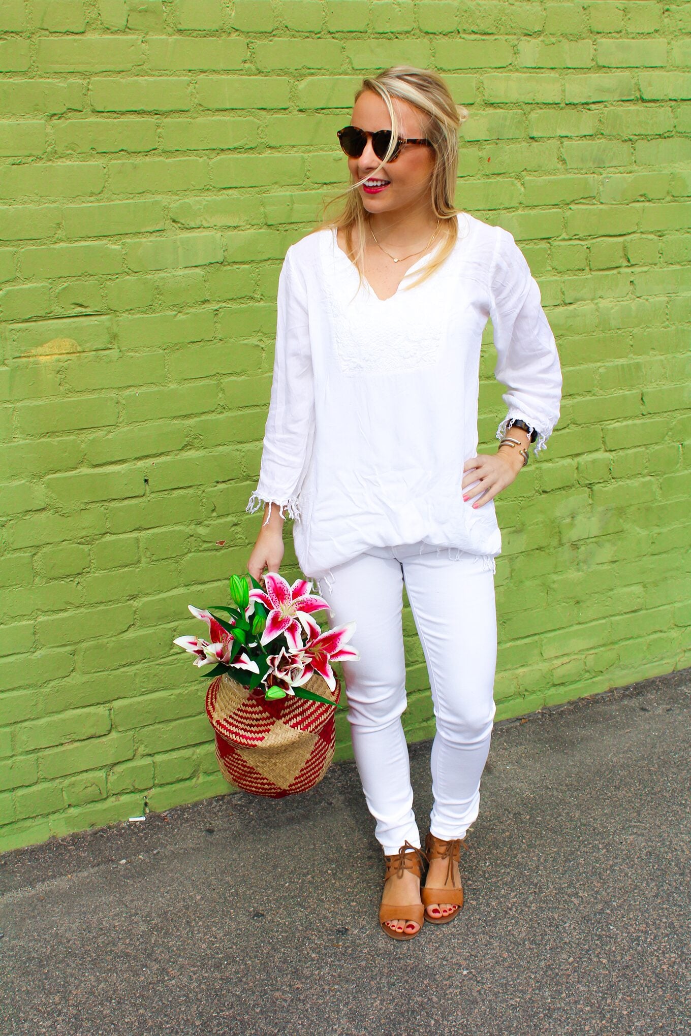 Amy Littleson from I Believe in Pink in white AG jeans with woven collapsible rice basket bag 