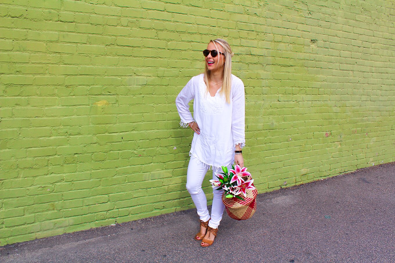 Amy Littleson from I Believe in Pink in white AG jeans with woven collapsible rice basket bag 