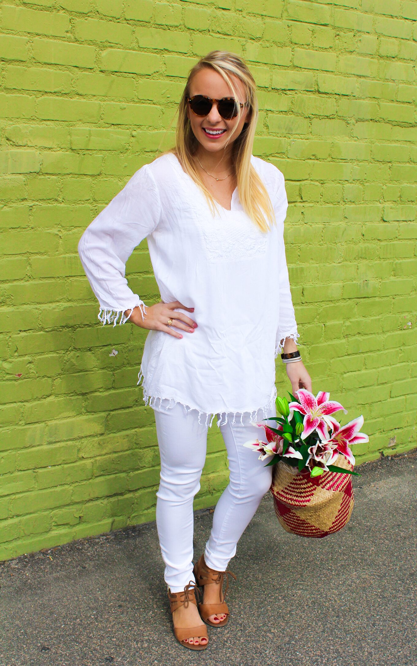 Amy Littleson from I Believe in Pink in white AG jeans with woven collapsible rice basket bag 