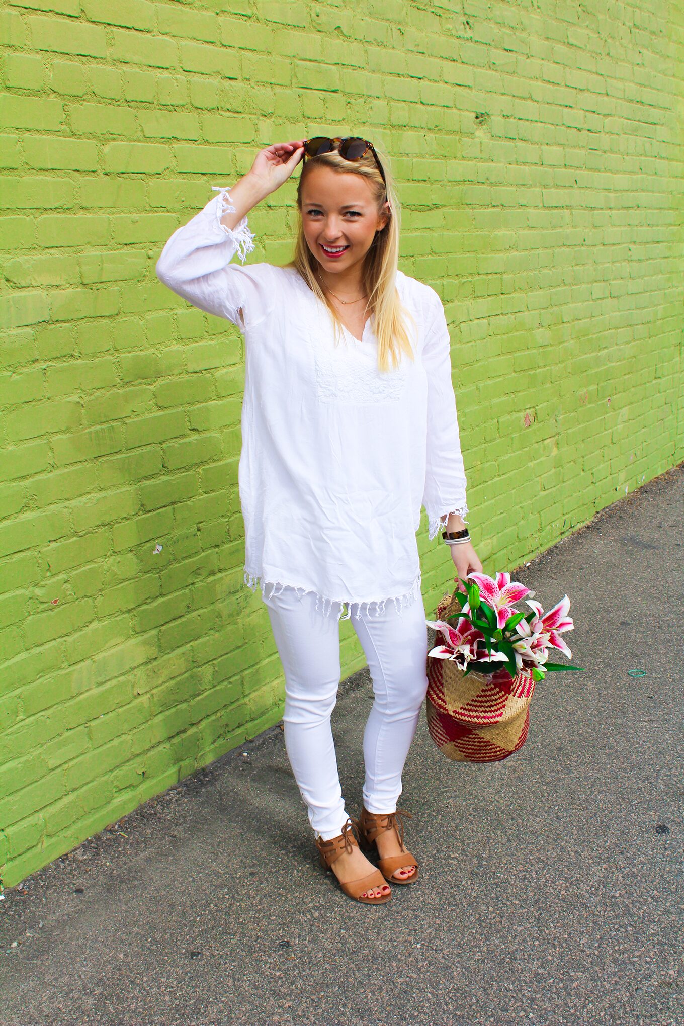 Amy Littleson from I Believe in Pink in white AG jeans with woven collapsible rice basket bag 