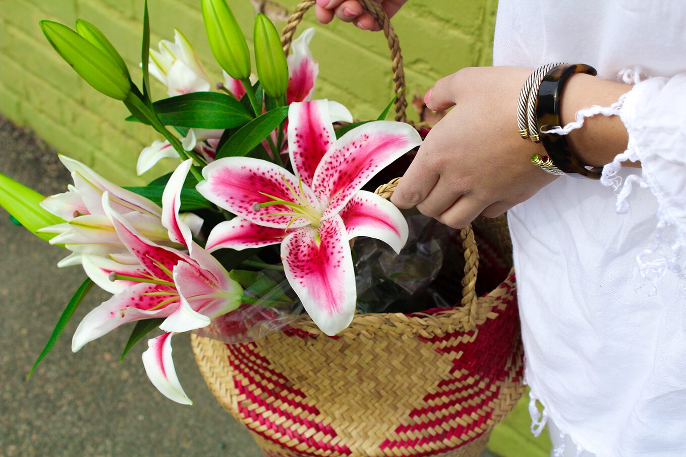 Amy Littleson from I Believe in Pink in white AG jeans with woven collapsible rice basket bag 