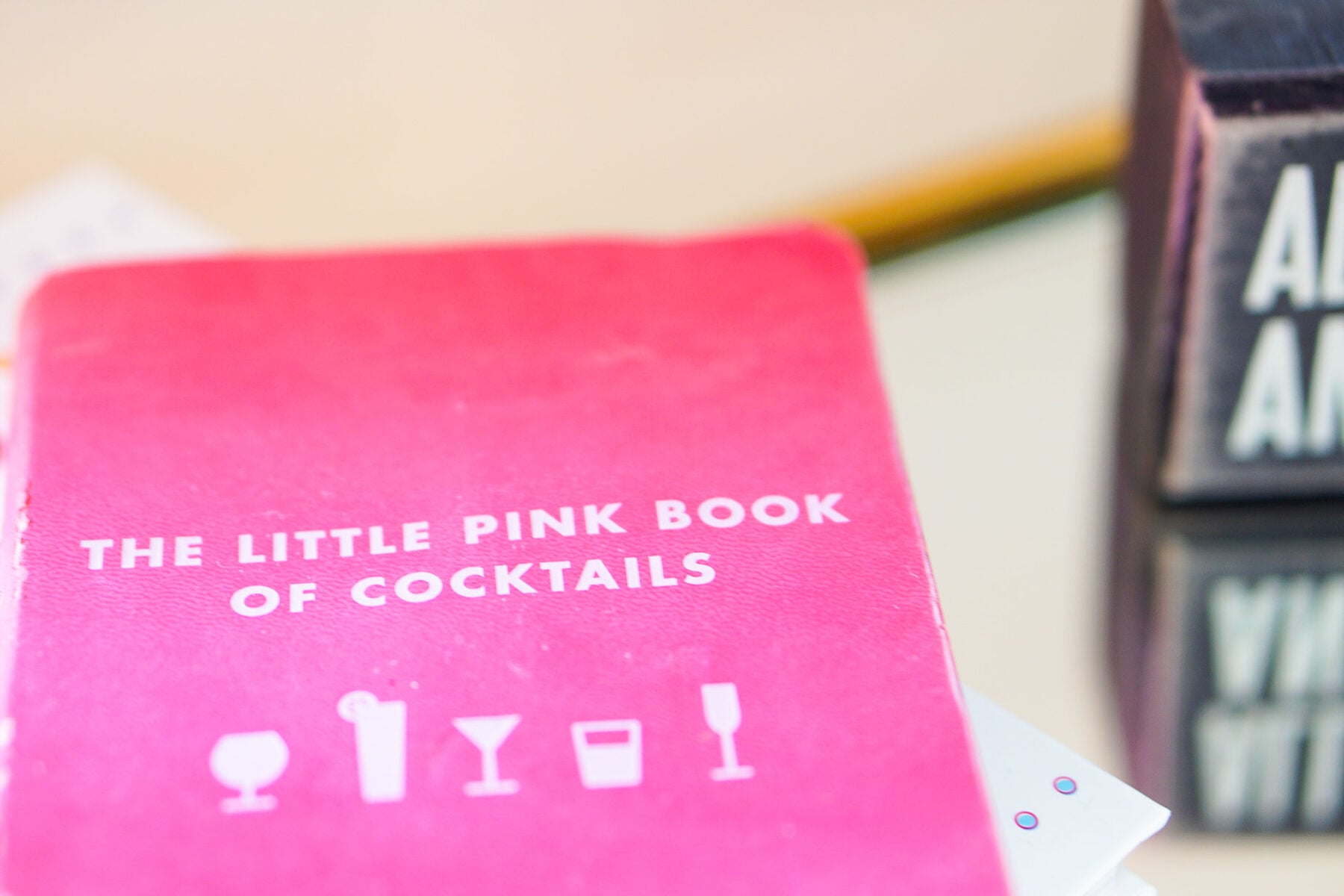 Gold bamboo bar card with pink and green banana leaf decorations in Philadelphia apartment