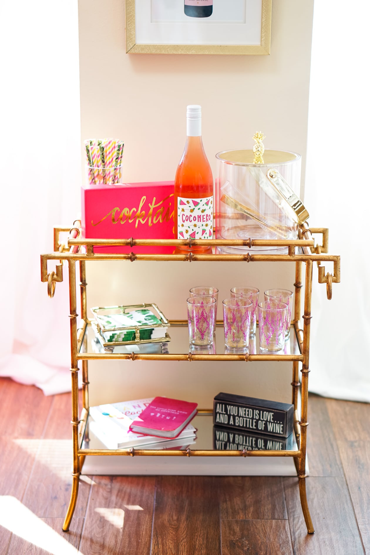 Gold bamboo bar card with pink and green banana leaf decorations in Philadelphia apartment