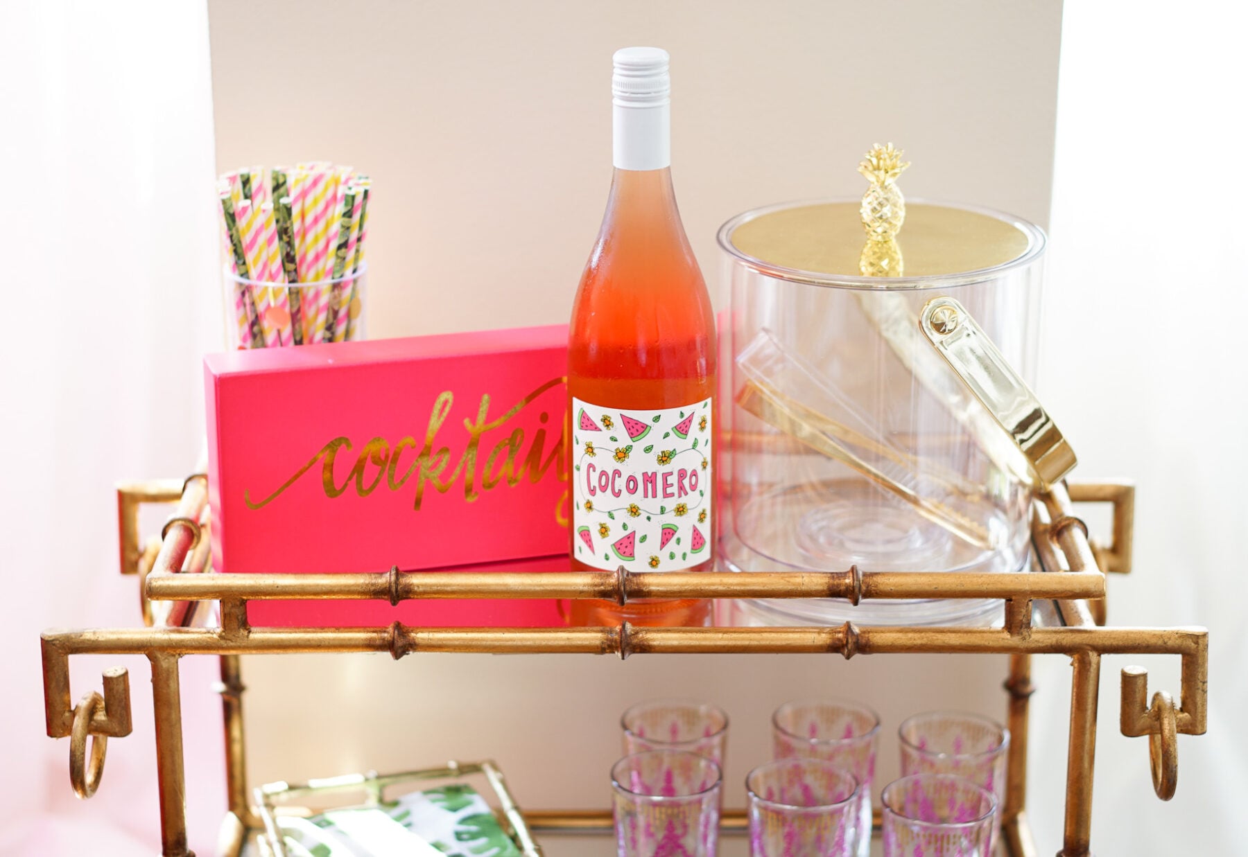 Gold bamboo bar card with pink and green banana leaf decorations in Philadelphia apartment