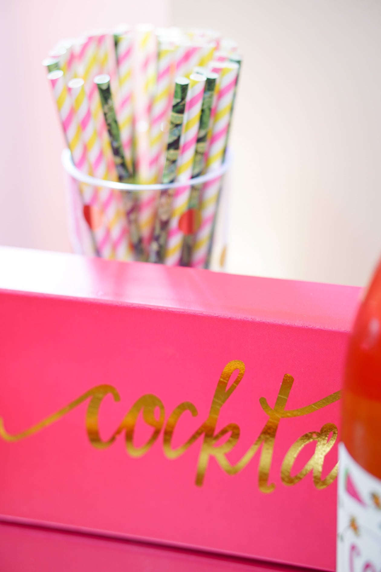 Gold bamboo bar card with pink and green banana leaf decorations in Philadelphia apartment