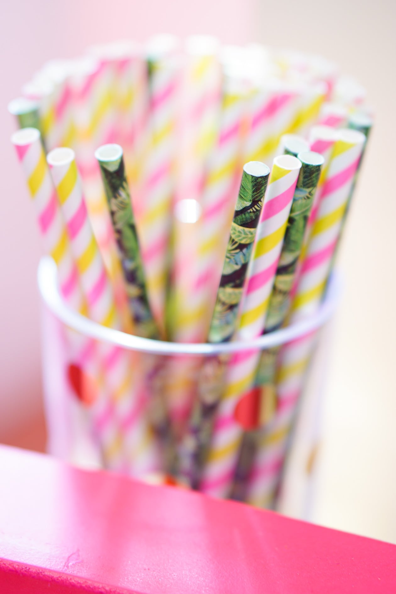 Gold bamboo bar card with pink and green banana leaf decorations in Philadelphia apartment