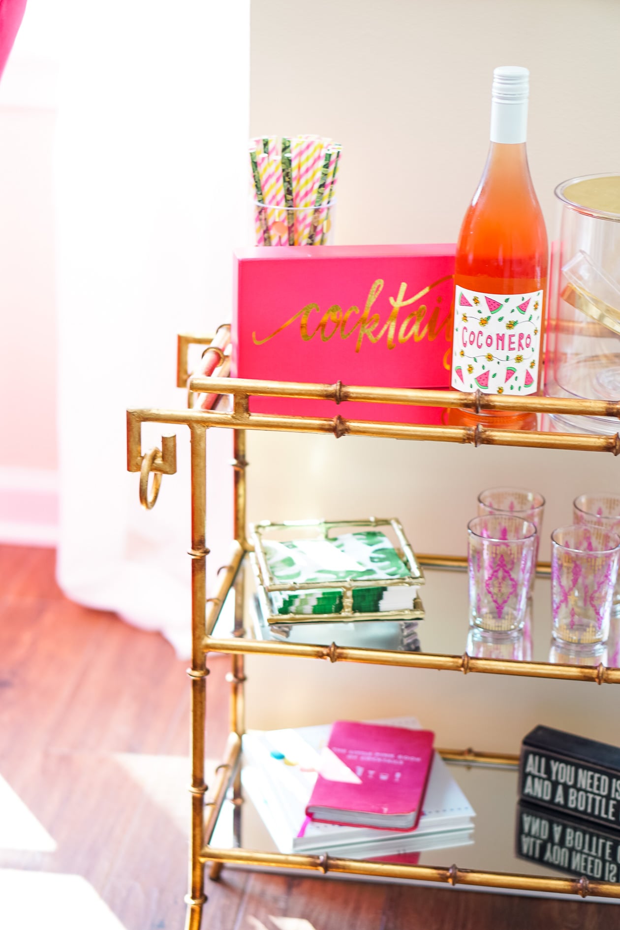 Gold bamboo bar card with pink and green banana leaf decorations in Philadelphia apartment