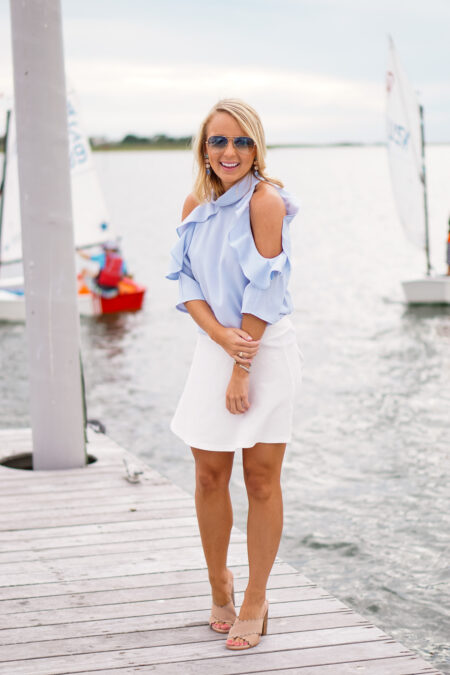 Blue ruffle Nordstrom top and Bauble Bar earrings and white skater skirt