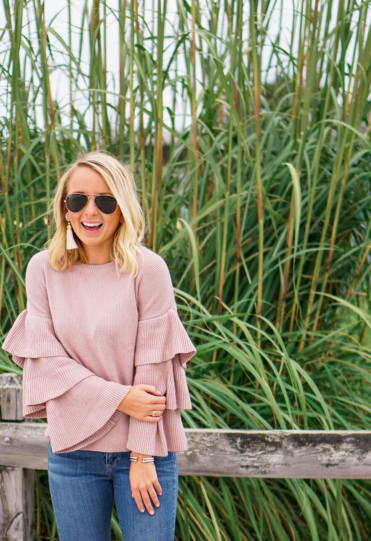 Blush ruffle Nordstrom sweater and bow booties with Lisi Lerch tassel earrings