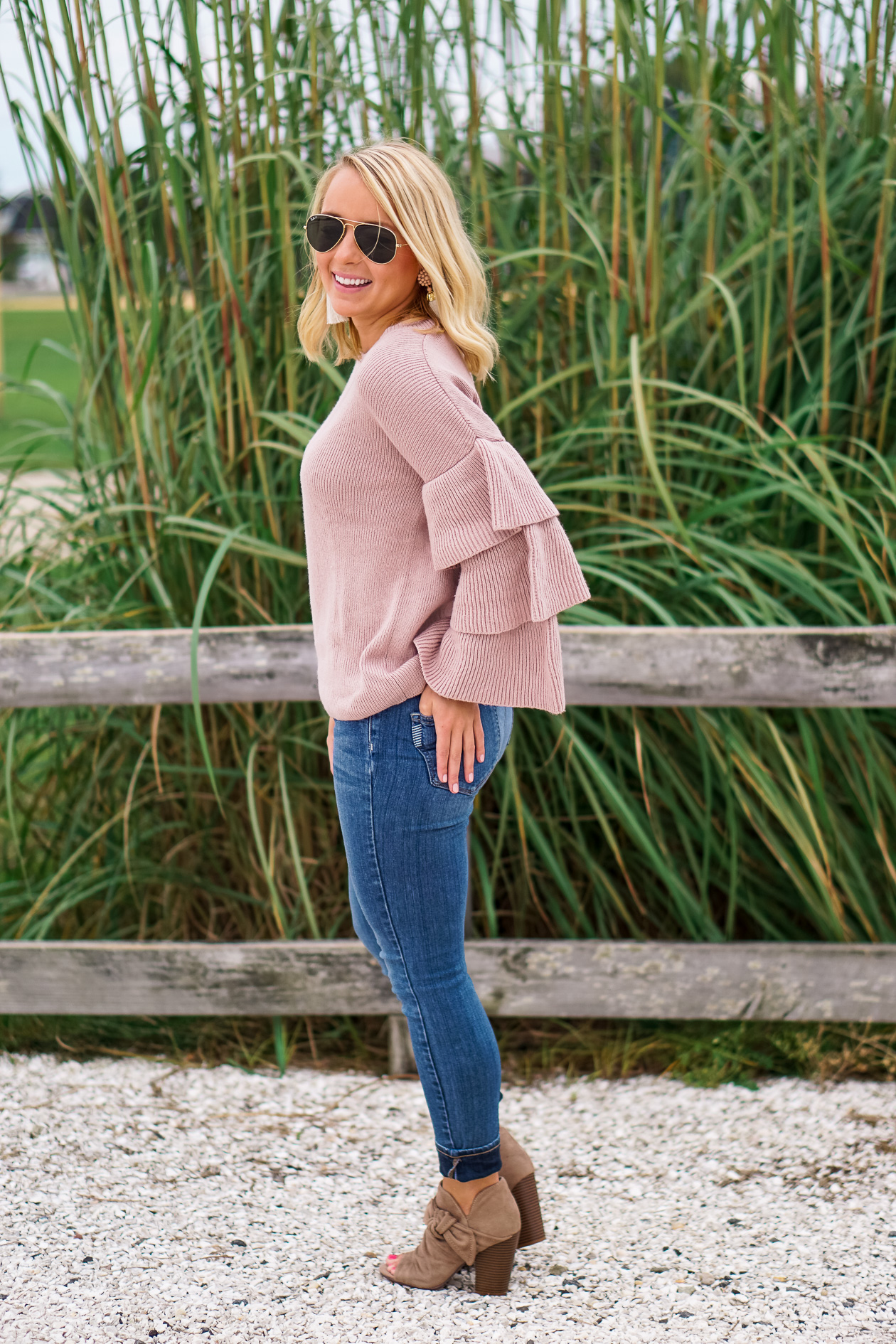 Blush ruffle Nordstrom sweater and bow booties with Lisi Lerch tassel earrings