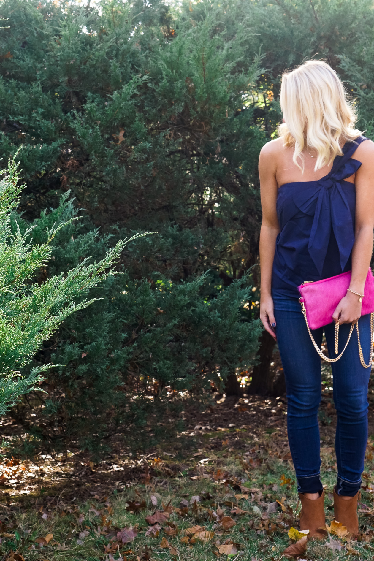 Navy J Crew bow top and pink cow hide clutch