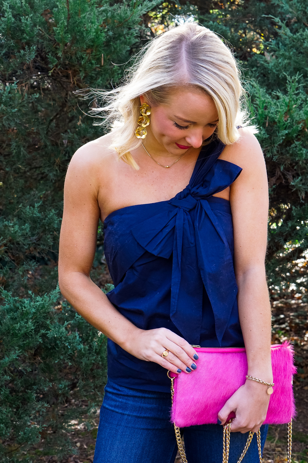 Navy J Crew bow top and pink cow hide clutch