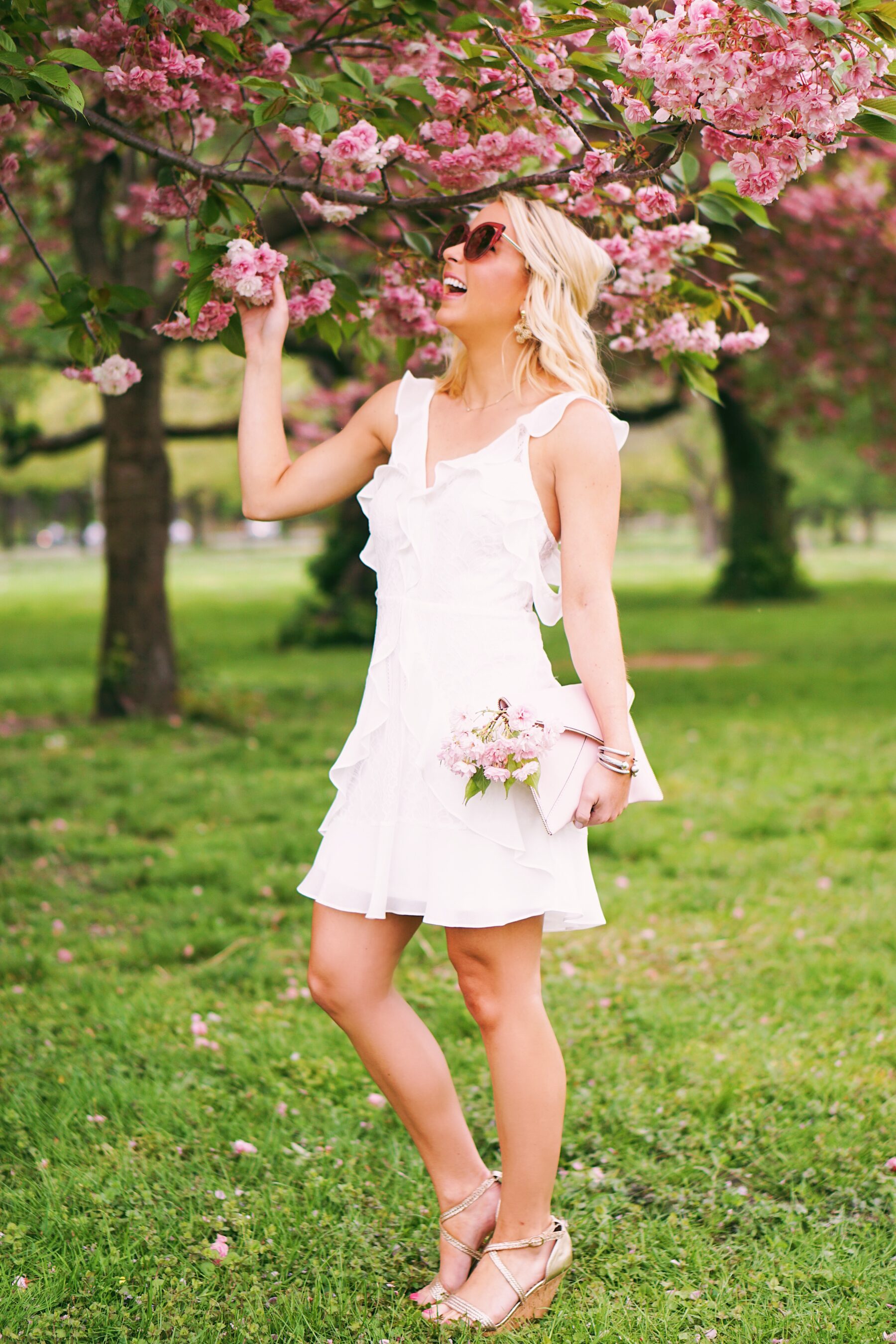 Red Dress Boutique white lace dress in cherry blossoms in Philadelphia