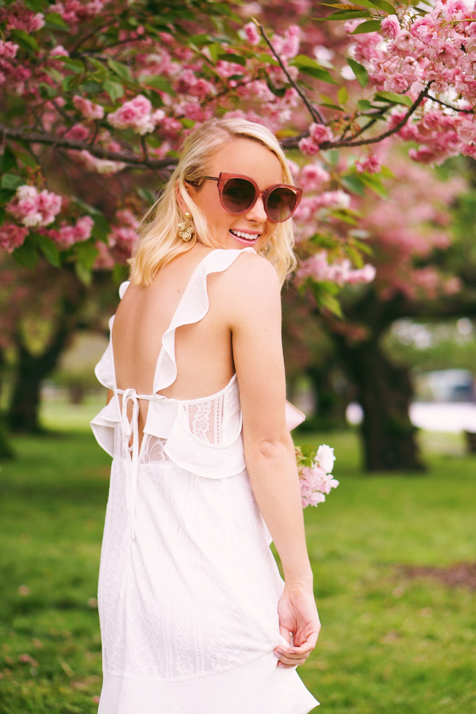 Red Dress Boutique white lace dress in cherry blossoms in Philadelphia