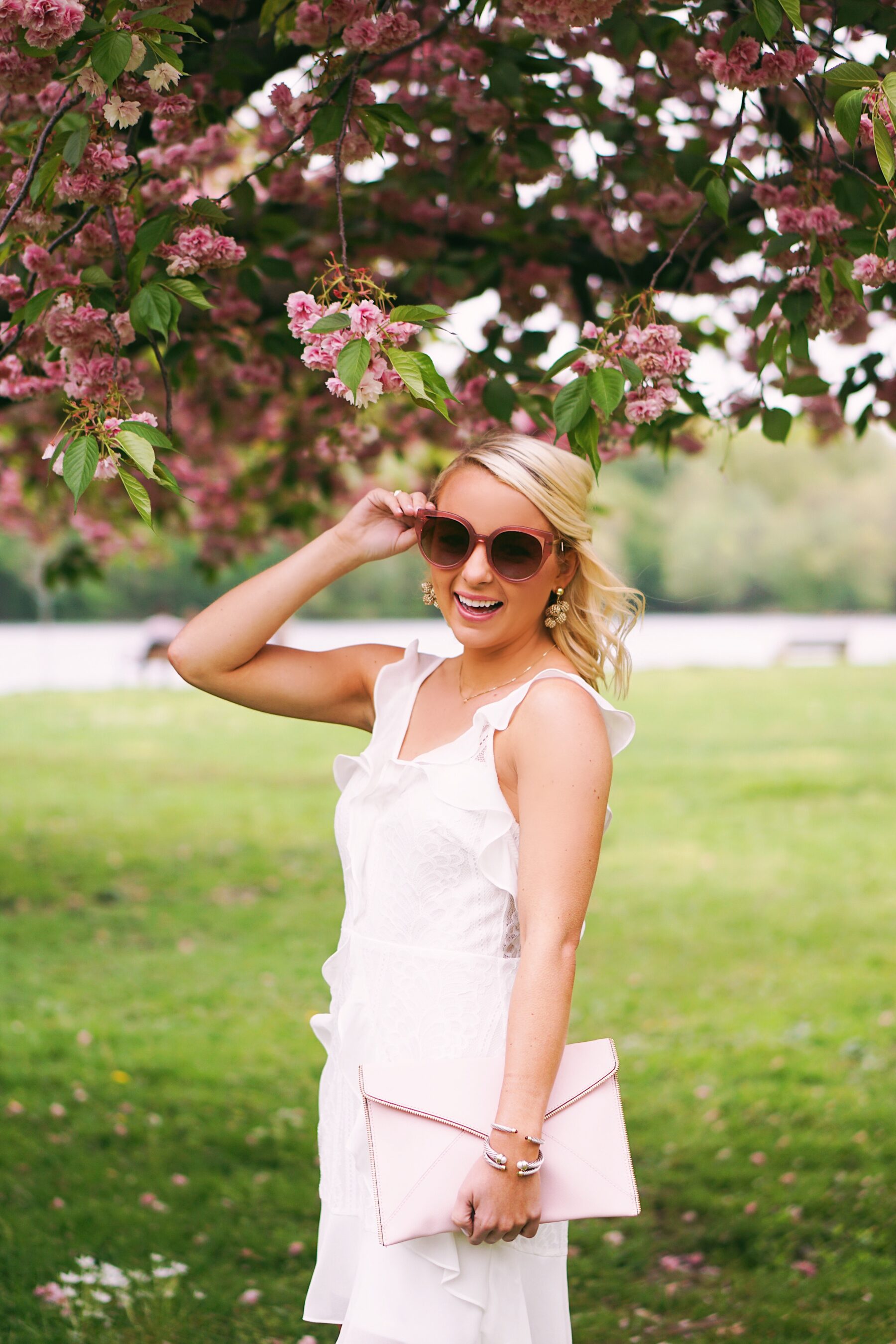 Red Dress Boutique white lace dress in cherry blossoms in Philadelphia
