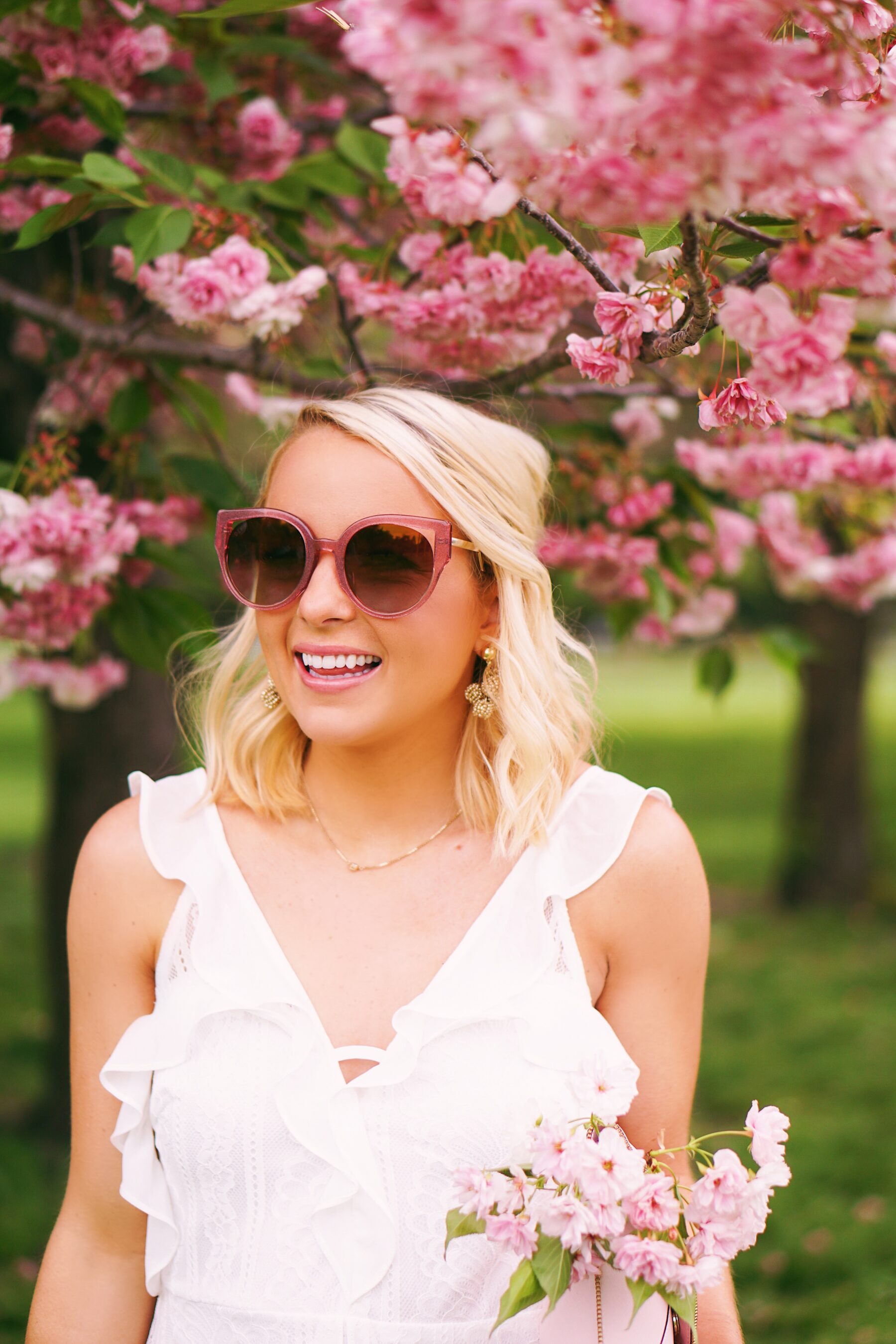 Red Dress Boutique white lace dress in cherry blossoms in Philadelphia