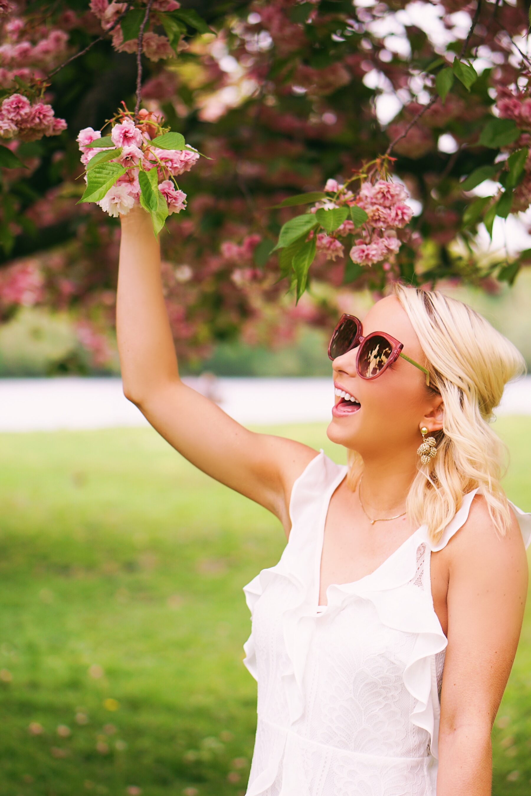 Red Dress Boutique white lace dress in cherry blossoms in Philadelphia