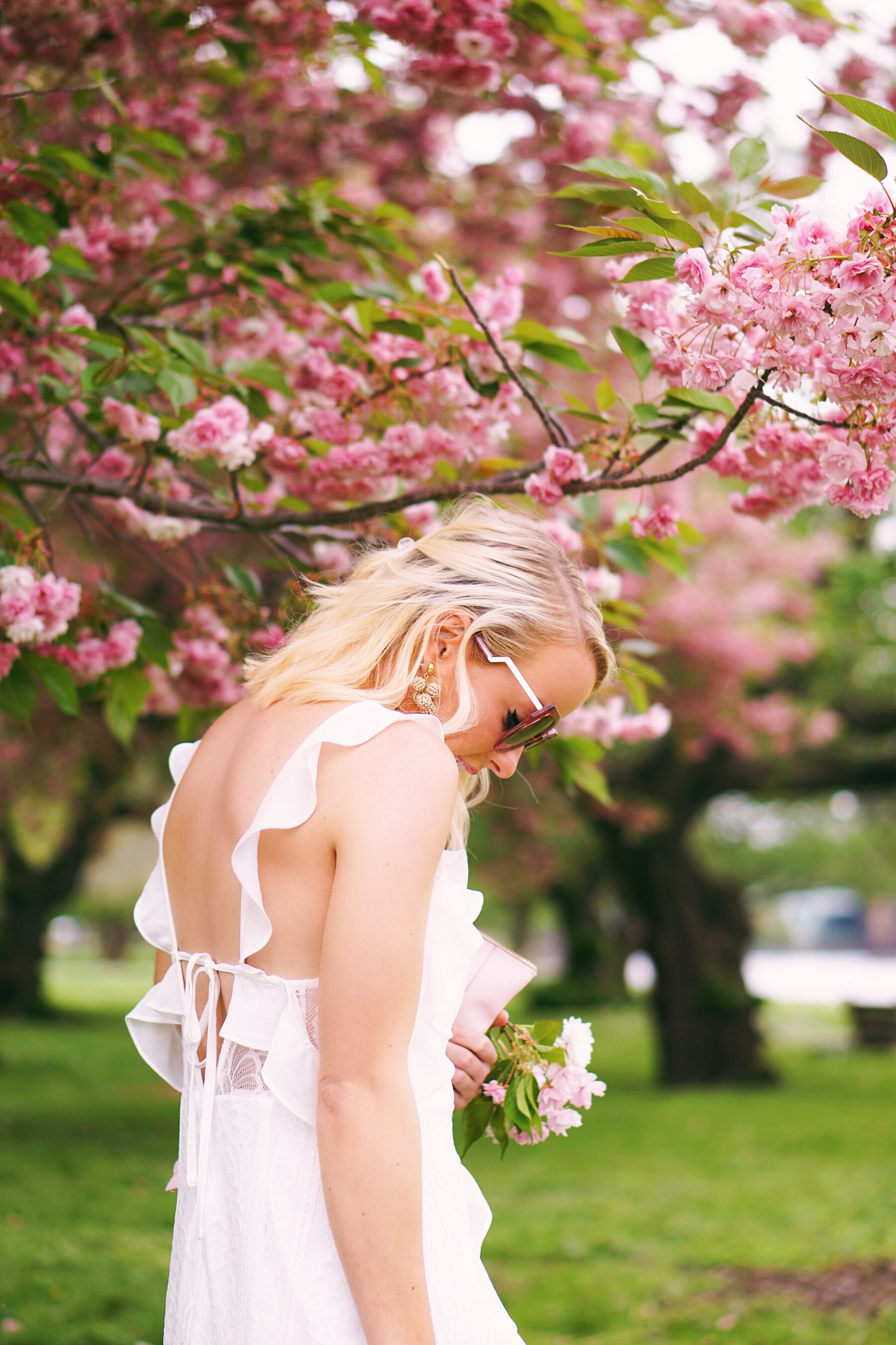 Red Dress Boutique white lace dress in cherry blossoms in Philadelphia